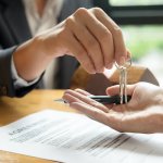 a man giving the keys to someone who will take over the payments for the house