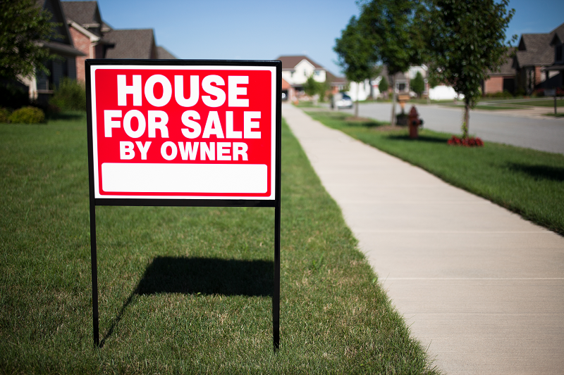 A house for sale by its owners with a sign that reads " House for sale by owner"