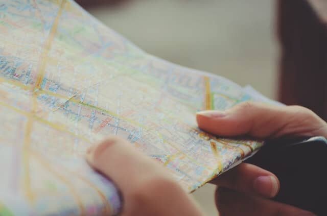 A woman’s hands holding a map.