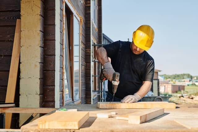 A man holding a drill.