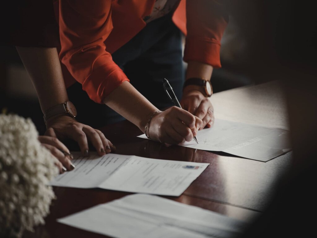 A person signing some documents.