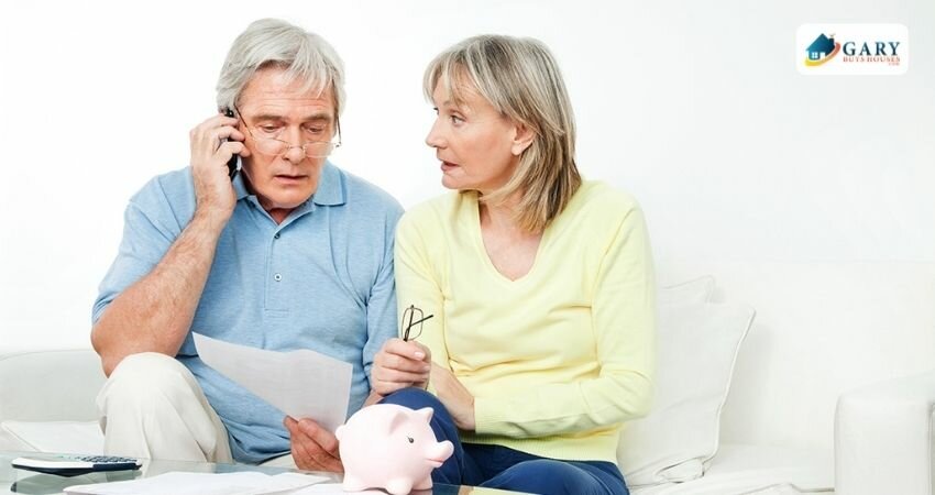 An elderly couple taking a phone call-problematic with their medical debt.