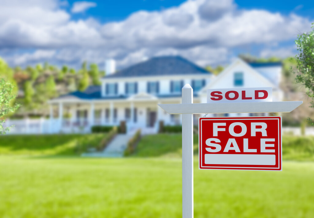 Sold Home For Sale Real Estate Sign in Front of Cottage House