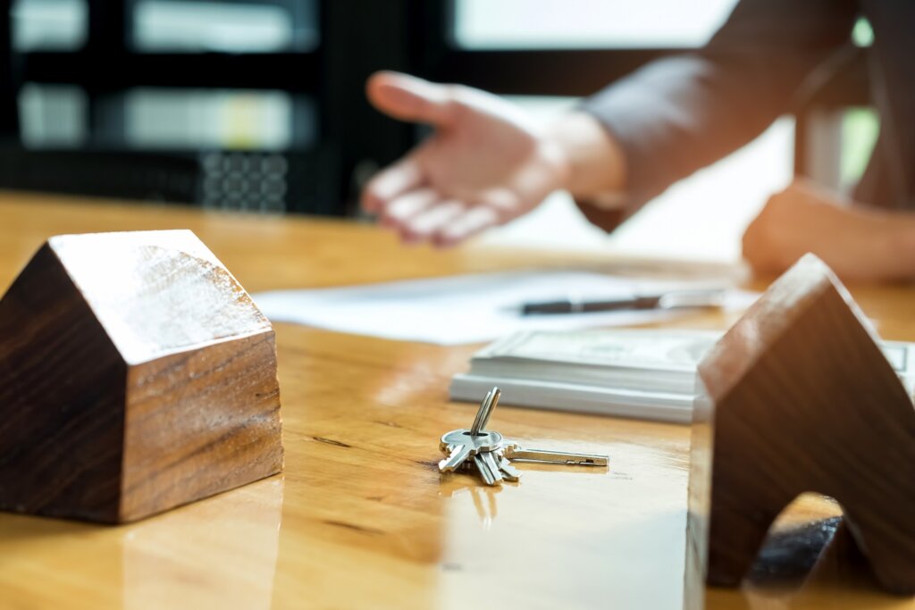 Sales are selling home. There are documents with the replica and the keys on the table.Real estate concept.