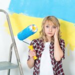 woman making repairs before selling her house
