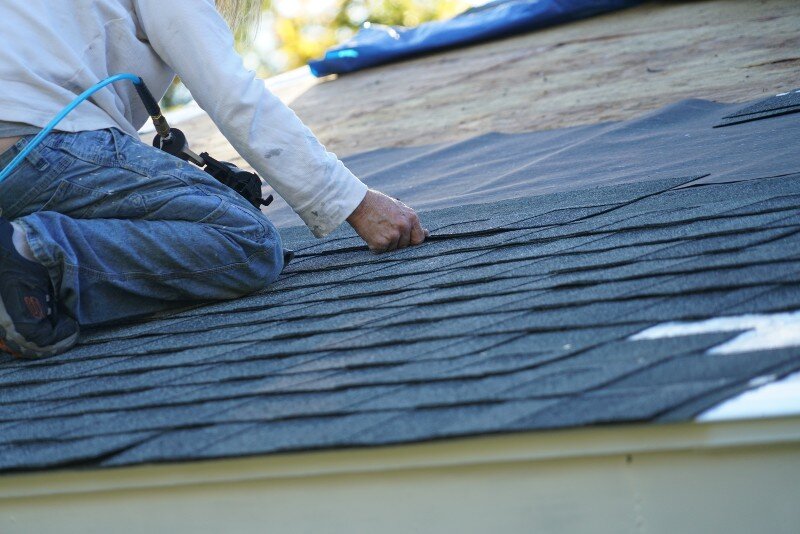 A man fixes a roof before a cash offer is made.