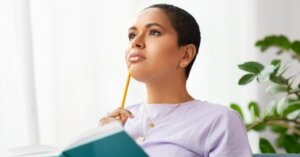 woman thinking at home about the market for home buyers