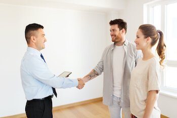 Man and woman shake hands with man