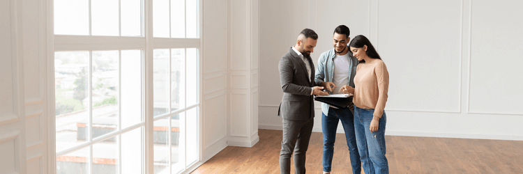 Photo of two young homeowners closing a deal with their local home buyer