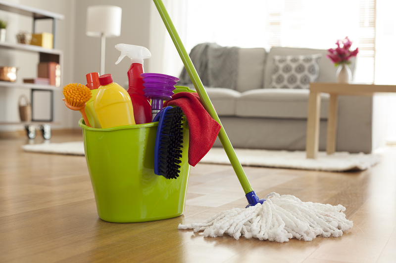 Photo of a mop with a lime green bucket and other house-cleaning tools