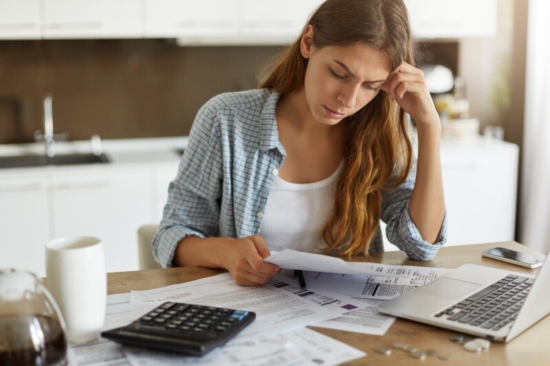 A woman going through some documentation and researching house permits. 