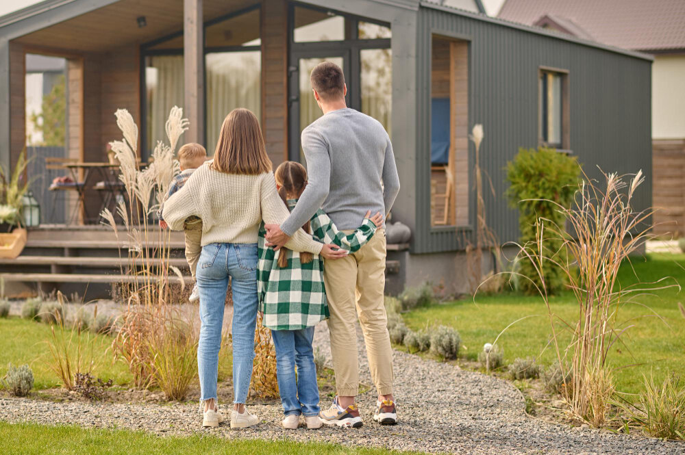 A happy family getting ready to move into a tiny house.