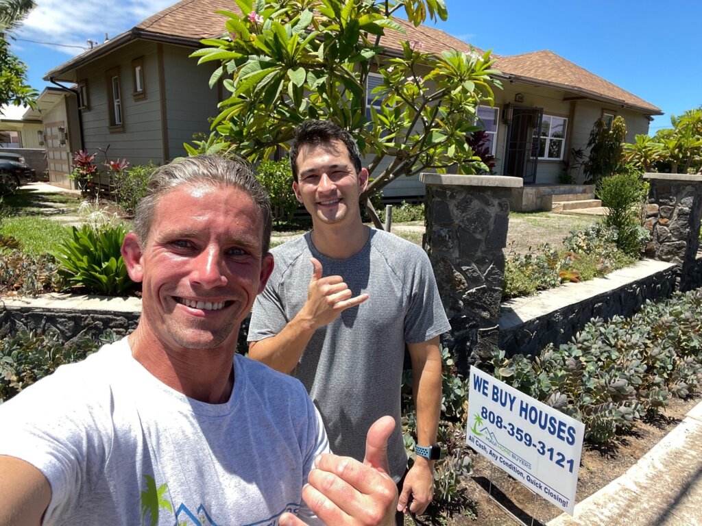 Greg and David from Maui Home Buyers standing in front of a Kahului house they bought for all cash