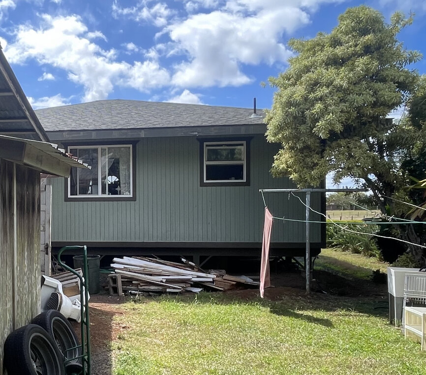 The back of a home in Haiku on the island of Maui, Hawaii during escrow while selling to Maui Home Buyers