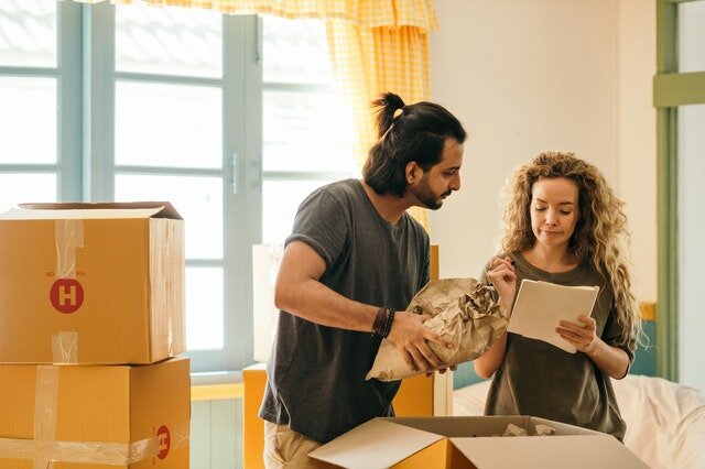 Two friends going through the list of tasks while packing and moving on short notice to Winston Salem.