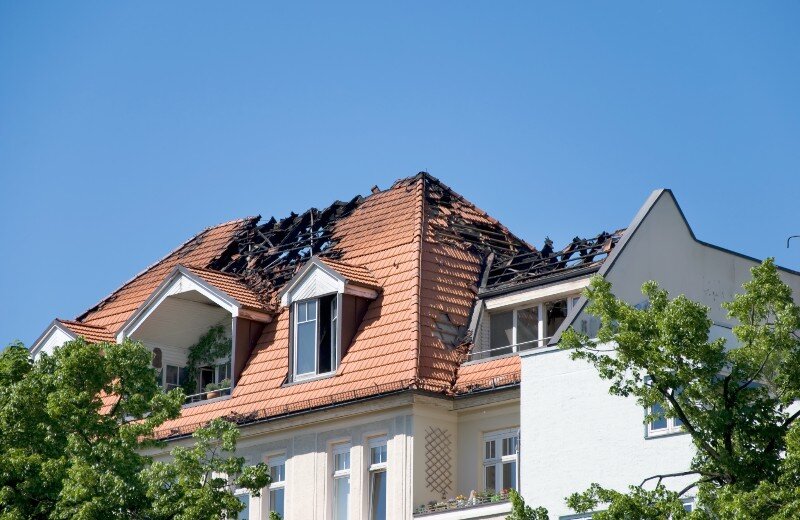 A house with roof-damaged after a fire.