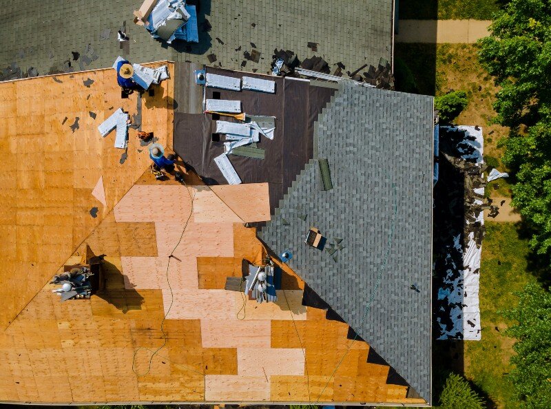 The roof of a home in Houston, TX is being fixed before the house is listed for sale.