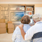 Senior couple hugging looking at packing their belongings.
