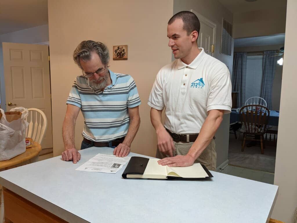212 Homes, LLC owner discussing an offer with a customer.