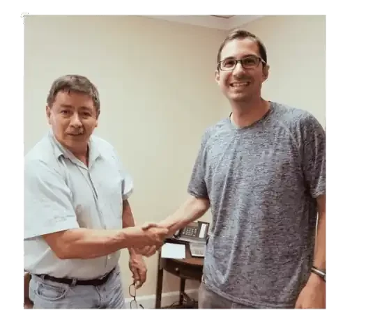John shaking client hand