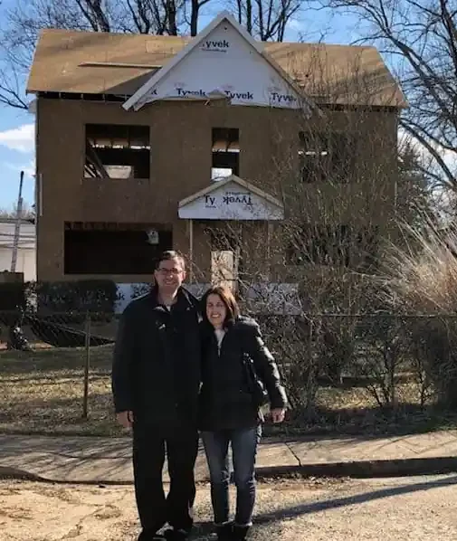 two people in front a house