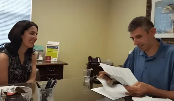 Elana Newman with a client at the closing table after completing a probate home sale