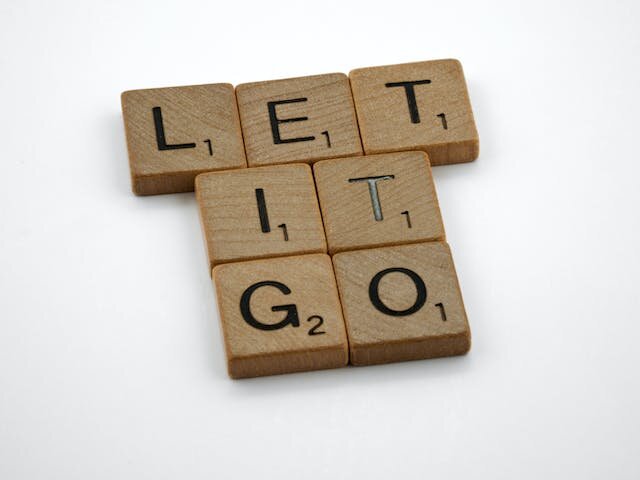 Scrabble tiles spelling out “let it go”