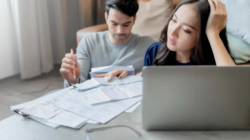 A man and a woman worrying about some papers