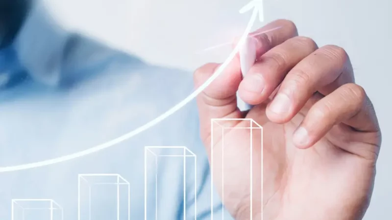 Man drawing an arrow on a chart