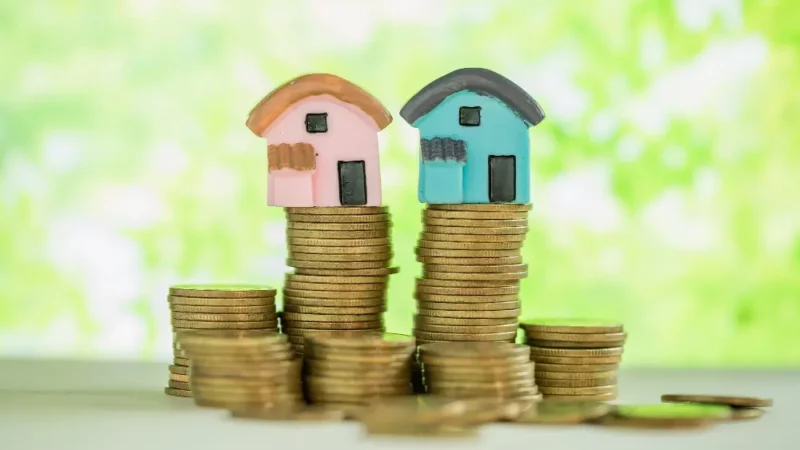 House on top of a stack of coins