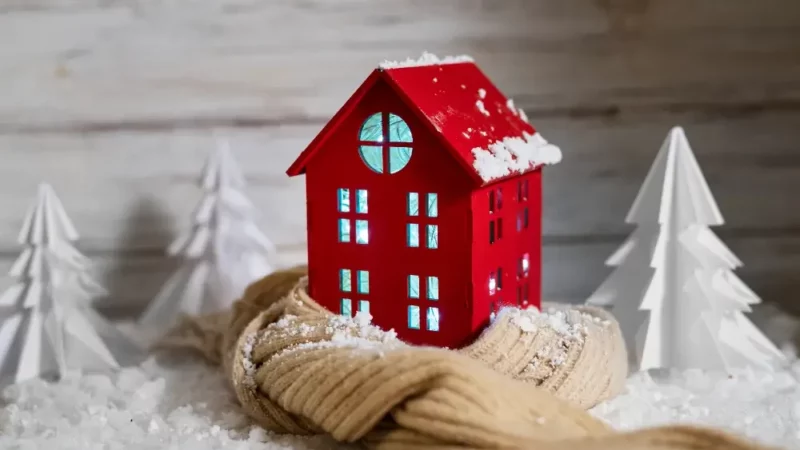 a red house sitting on top of a pile of snow