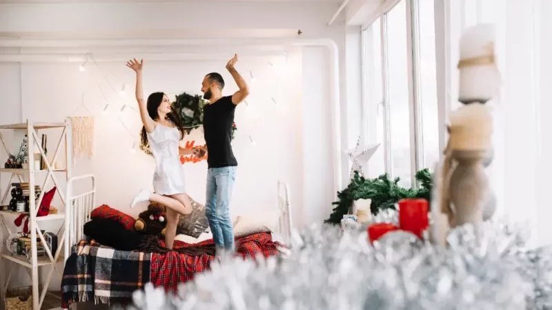 a man and a woman standing on a bed