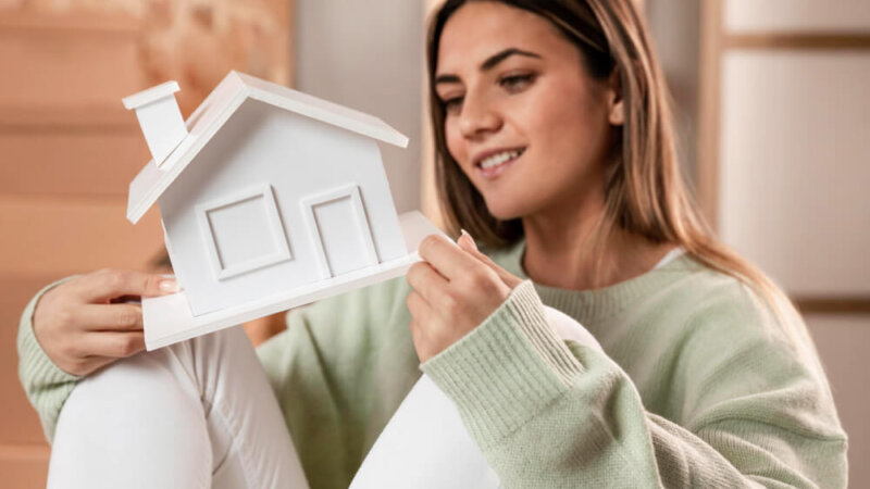 Woman holding a house