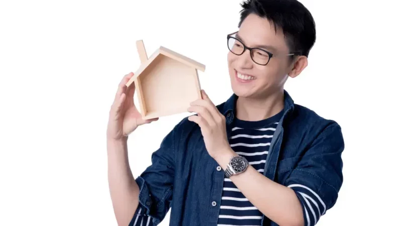 Man holding a wooden house