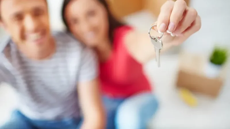 Man and a woman holding a key