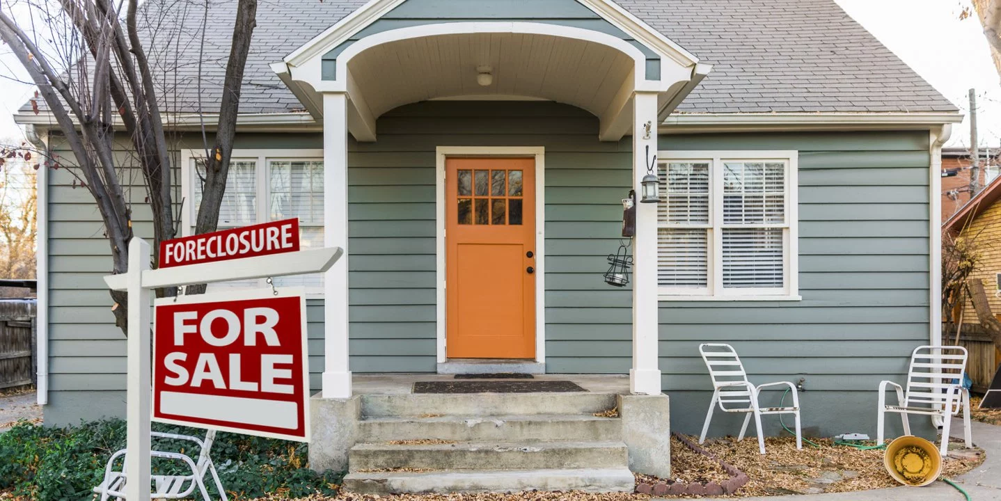 Single-family South Carolina home with a red foreclosure sign in the front yard, symbolizing a homeowner needing fast mortgage relief or a cash offer from Table Rock Homebuyers.