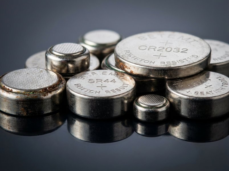 Button cell and watch batteries including CR2032 coin cells and hearing aid batteries — contain mercury or silver and must never go in Buffalo NY trash, accepted at Batteries Plus Amherst