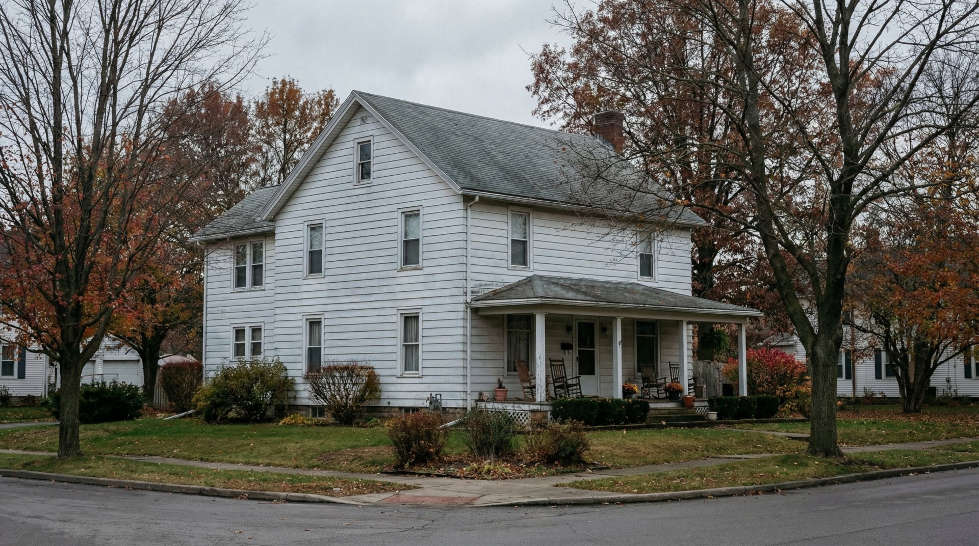 Exterior of a classic Western New York two-story home at dusk — a Buffalo area family home being considered for sale to fund assisted living care for an aging parent or family member